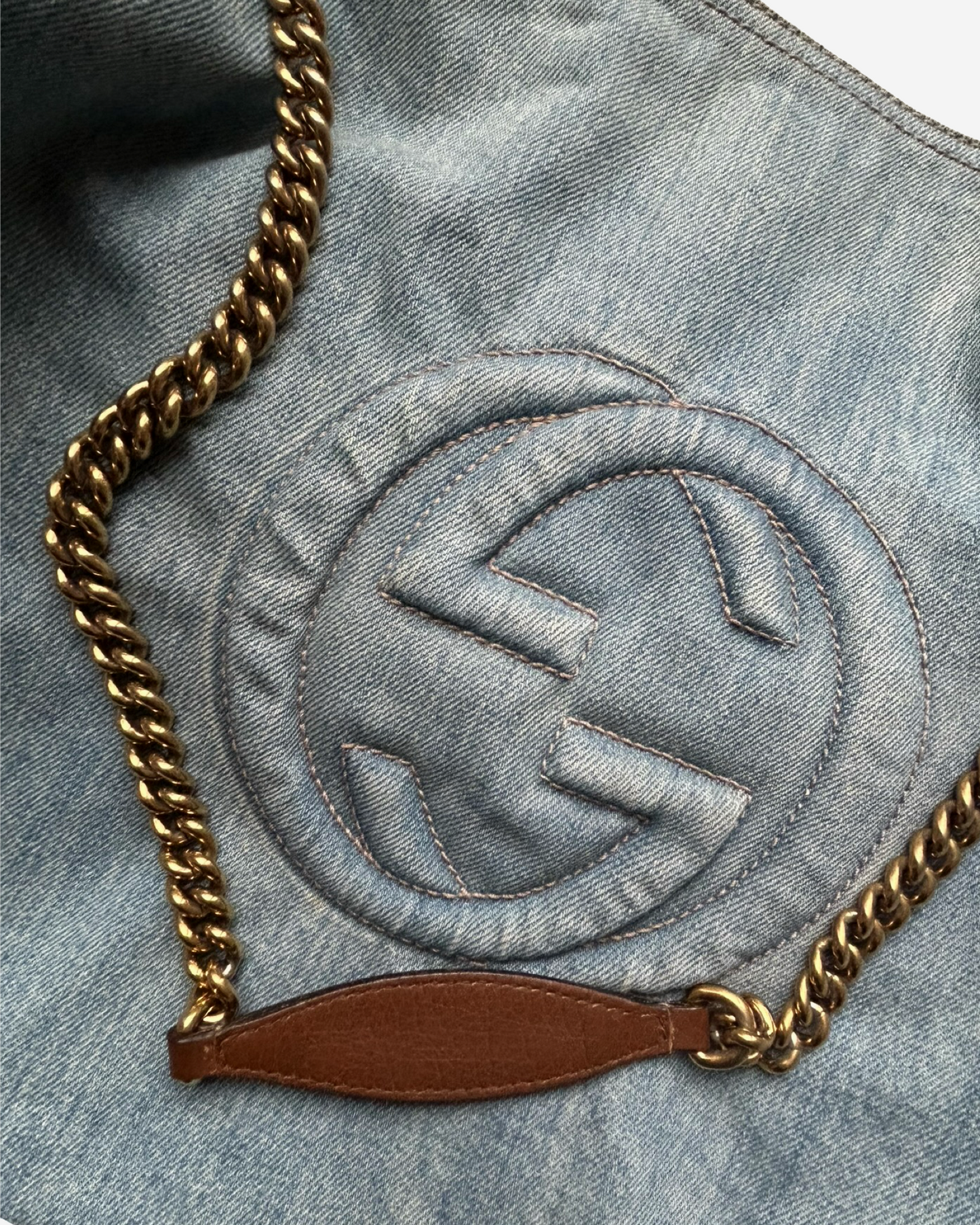 Close-up of embossed GG logo on Gucci Soho Denim Shoulder Bag Blue