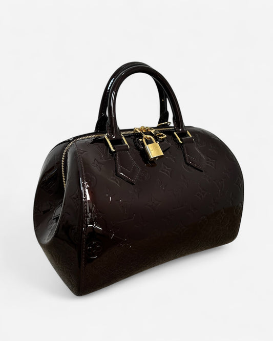 Louis Vuitton Montana Monogram Vernis bag in aubergine – side profile with structured silhouette