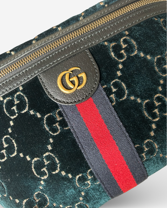 Close-up of GG logo and gold-tone hardware on Gucci Ophidia Belt Bag in blue velvet