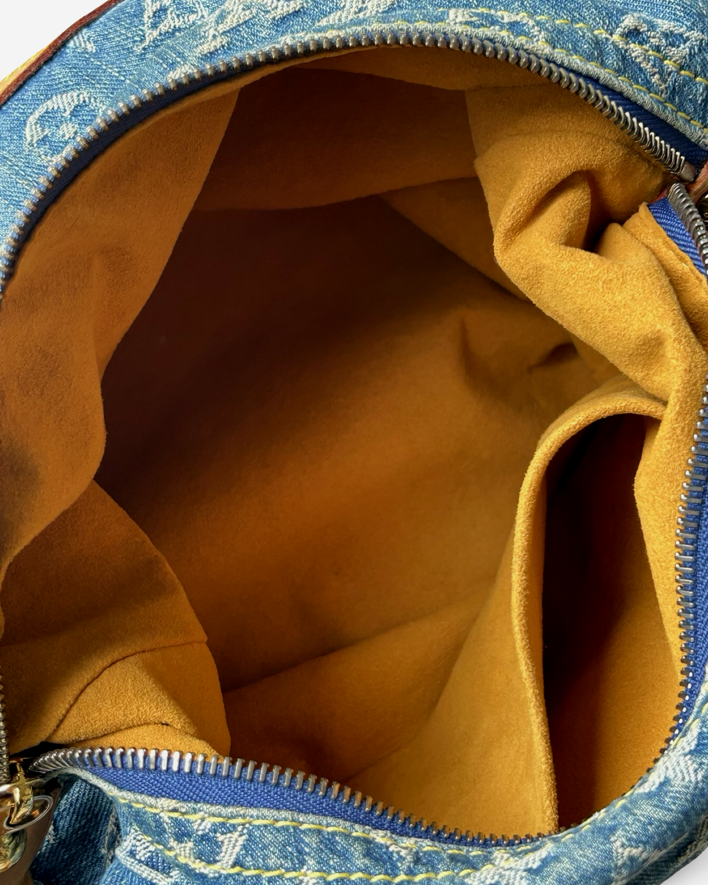 Interior view of the Louis Vuitton Monogram Denim Baggy GM Shoulder Bag, showcasing plush lining and spacious compartment.