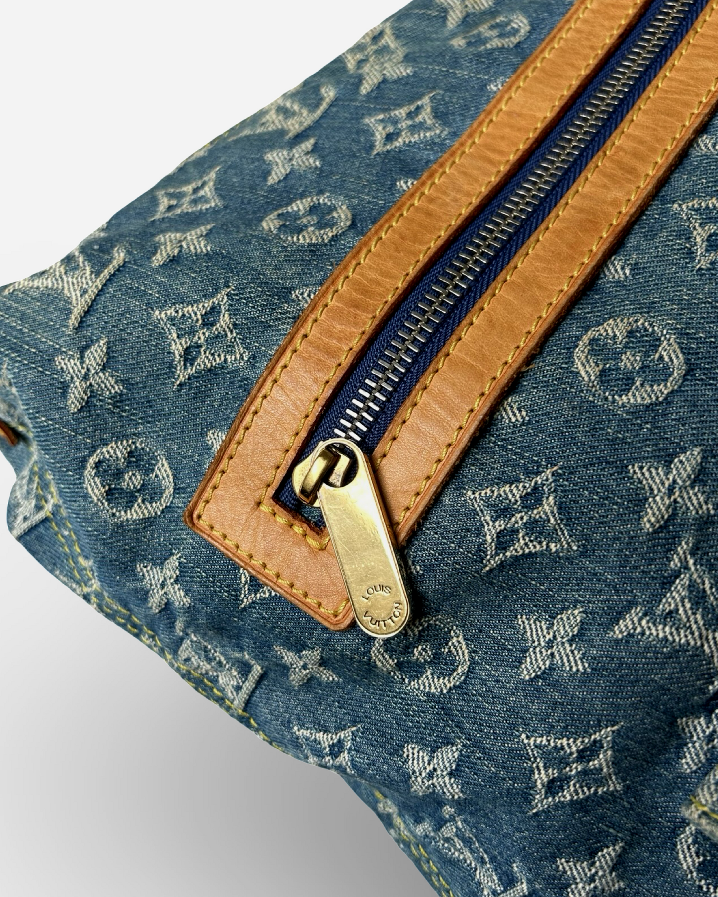 Close-up of Louis Vuitton Monogram Denim Baggy GM Shoulder Bag showing zipper and Vachetta leather trim.