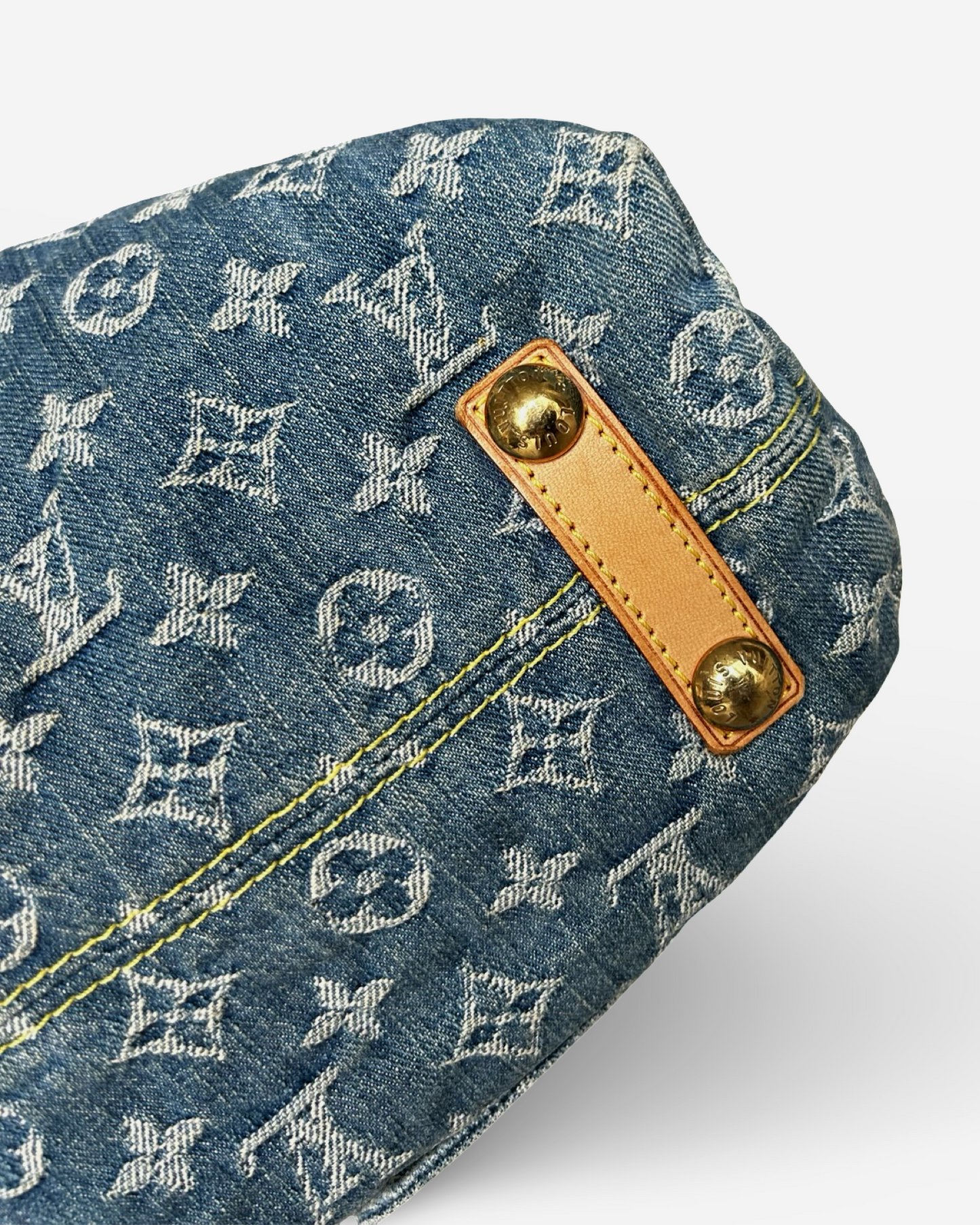 Louis Vuitton Monogram Denim Baggy GM Shoulder Bag detail showing blue denim and Vachetta leather trim.