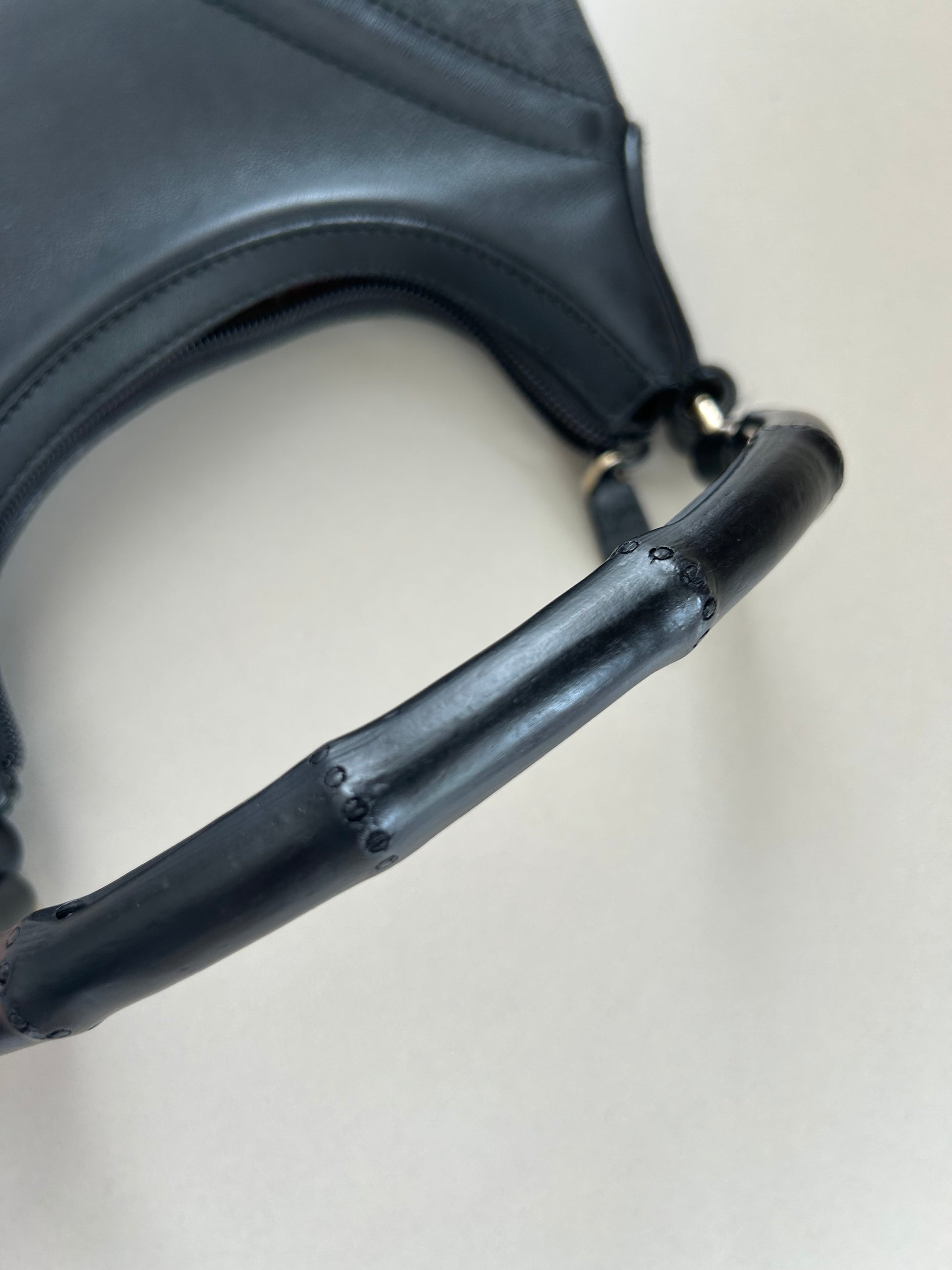 Close-up of bamboo top handles on Gucci Hysteria Crest Bamboo black leather handbag