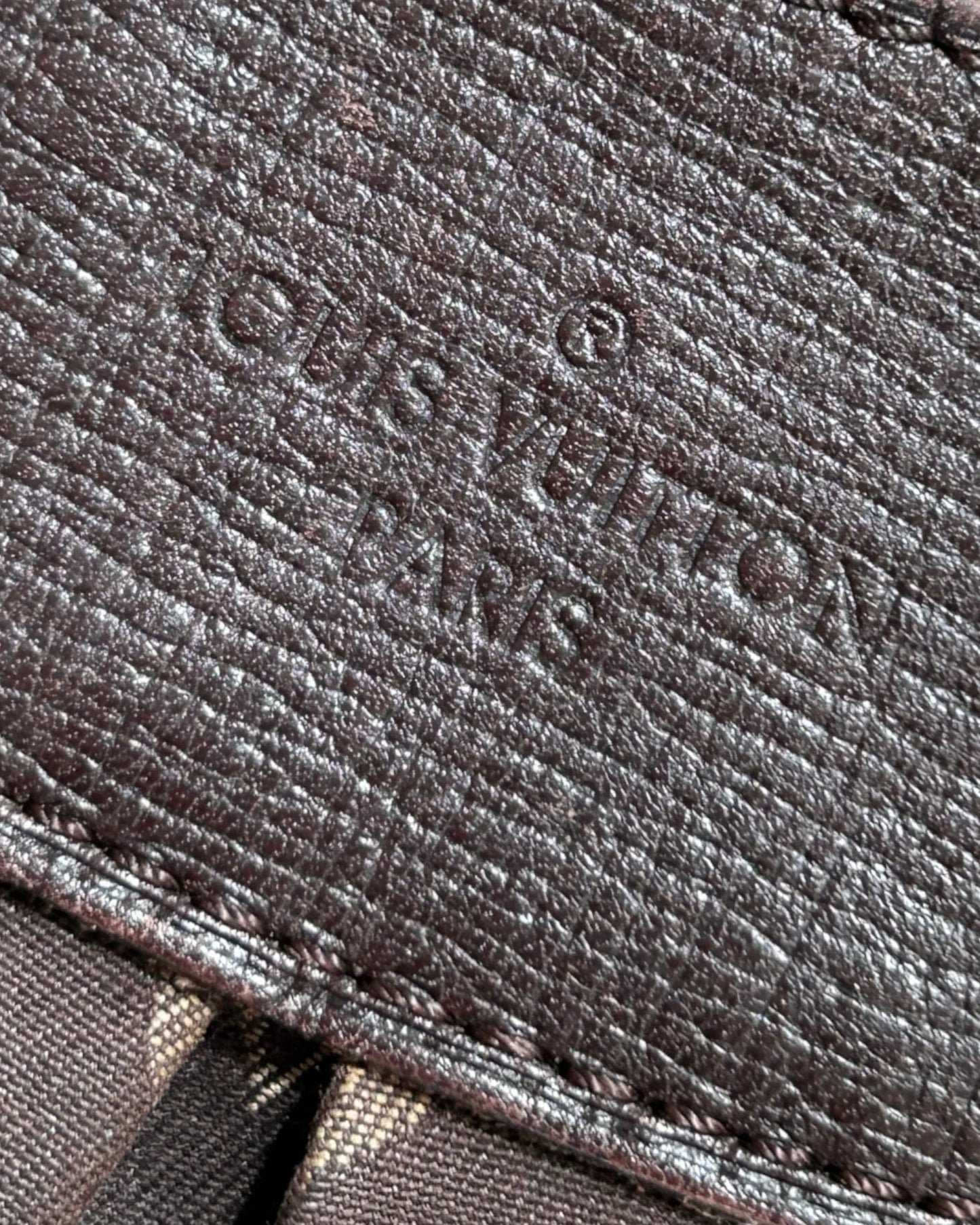 Close-up of Louis Vuitton Monogram Idylle pattern on Rhapsody MM in brown canvas