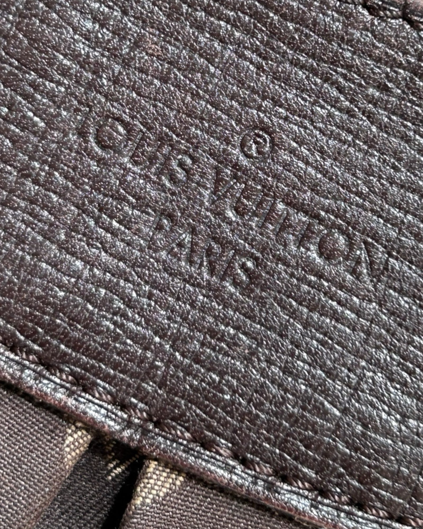 Close-up of Louis Vuitton Monogram Idylle pattern on Rhapsody MM in brown canvas