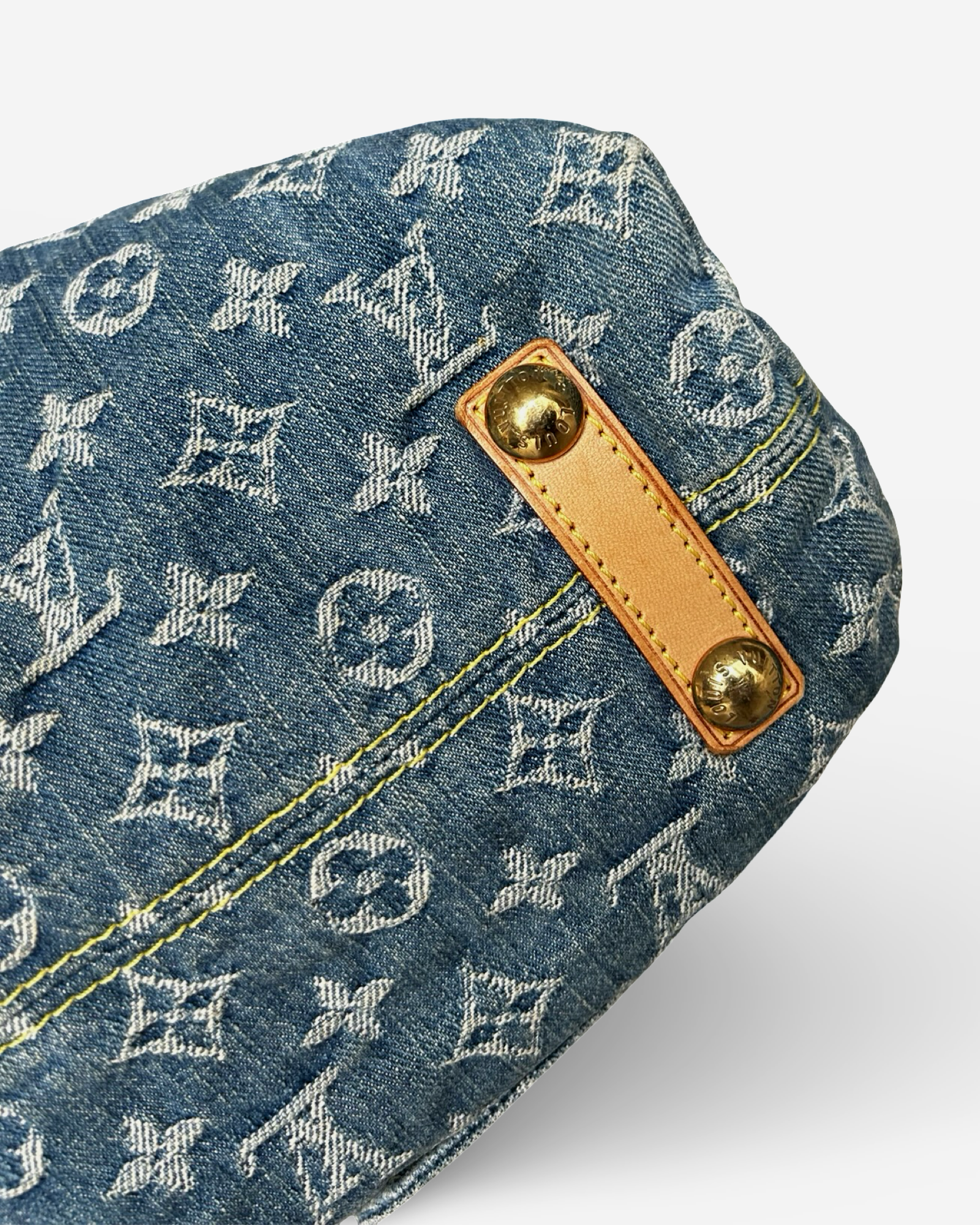 Louis Vuitton Monogram Denim Baggy GM Shoulder Bag detail showing blue denim and Vachetta leather trim.
