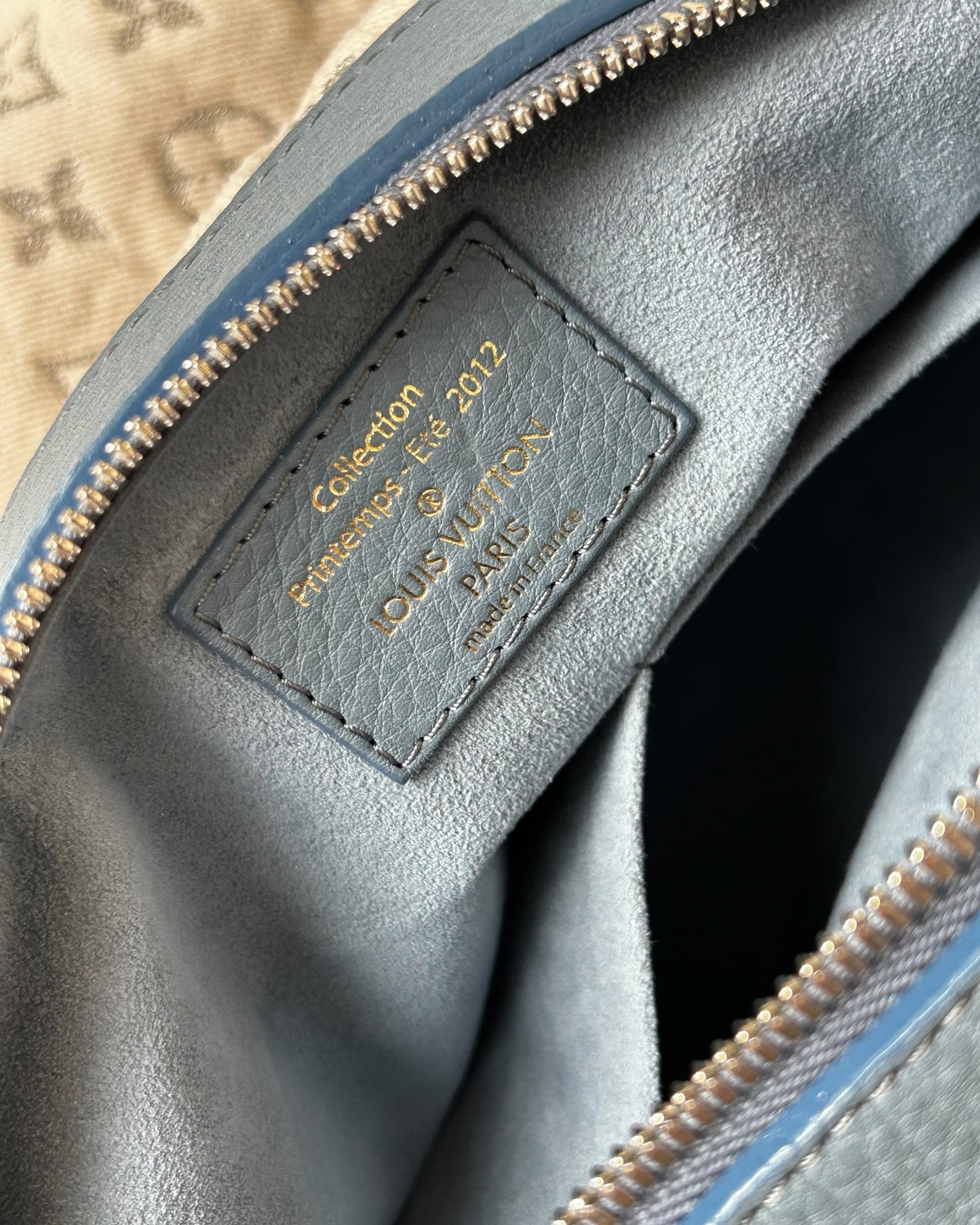Close-up of Louis Vuitton Monogram logo on Speedy Round bag in white stonewashed denim – 2012 limited edition