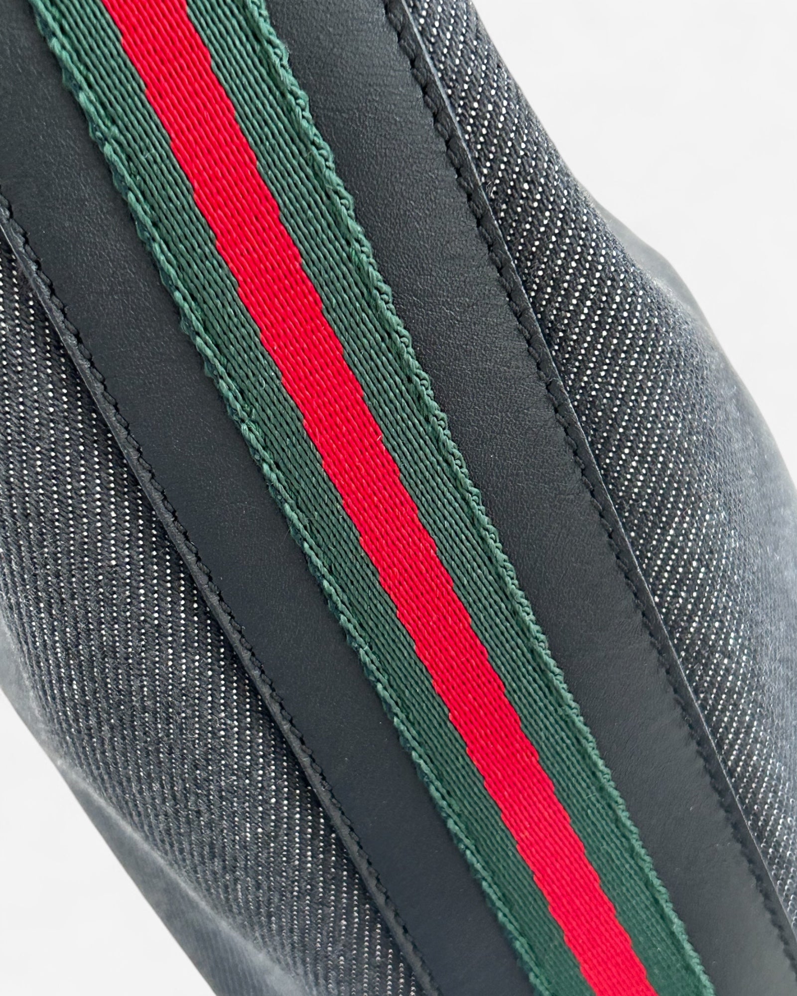 top handle of black denim gucci web hobo bag side stripes