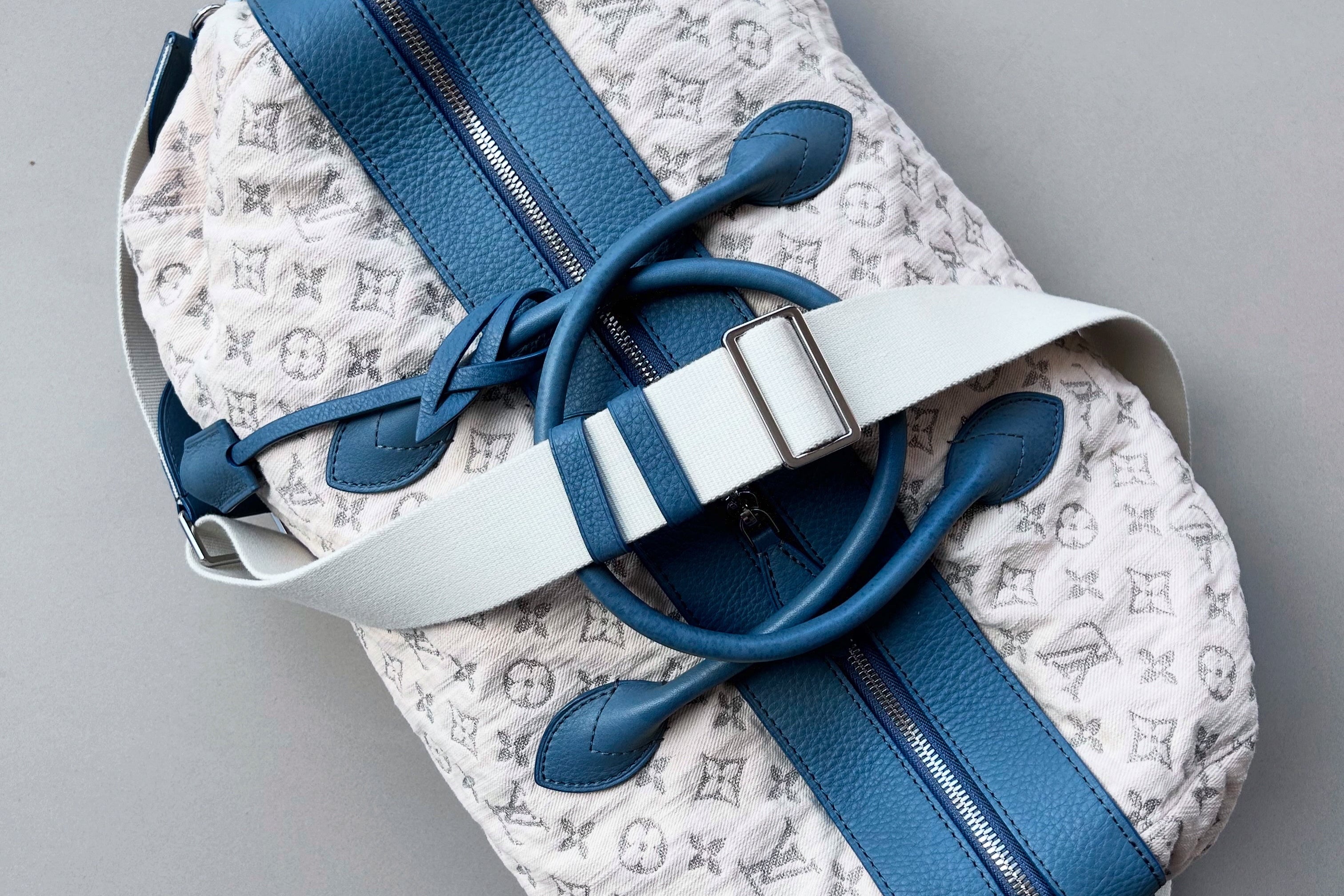 Louis Vuitton Keepall in white monogram canvas with blue leather accents