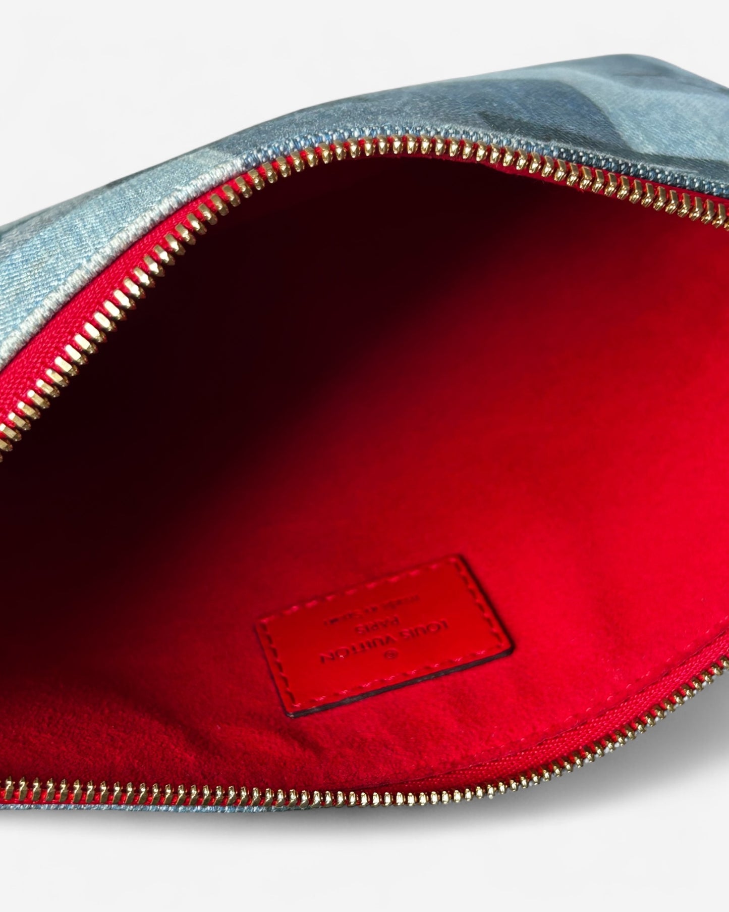 interior view of louis vuitton patchwork pouch with red lining