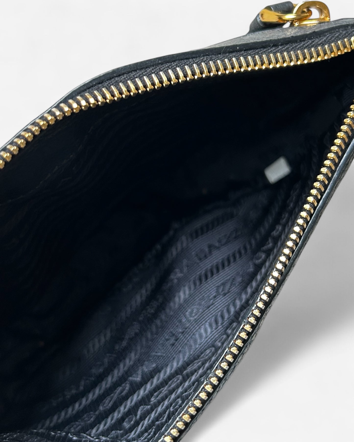 interior view of prada belt bag with black fabric lining