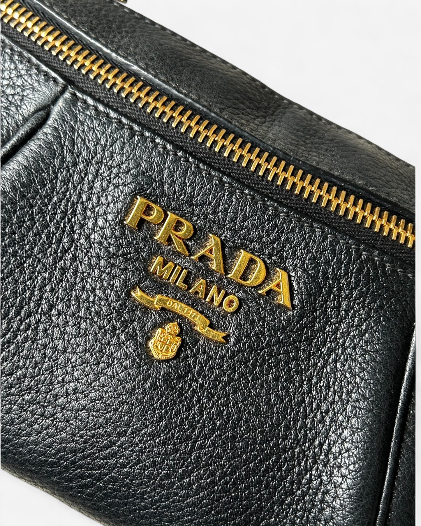close-up of prada logo on textured vitello daino leather